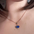 13 x 7mm triangular Australian opal doublet pendant worn at the neck, rose gold-plated silver