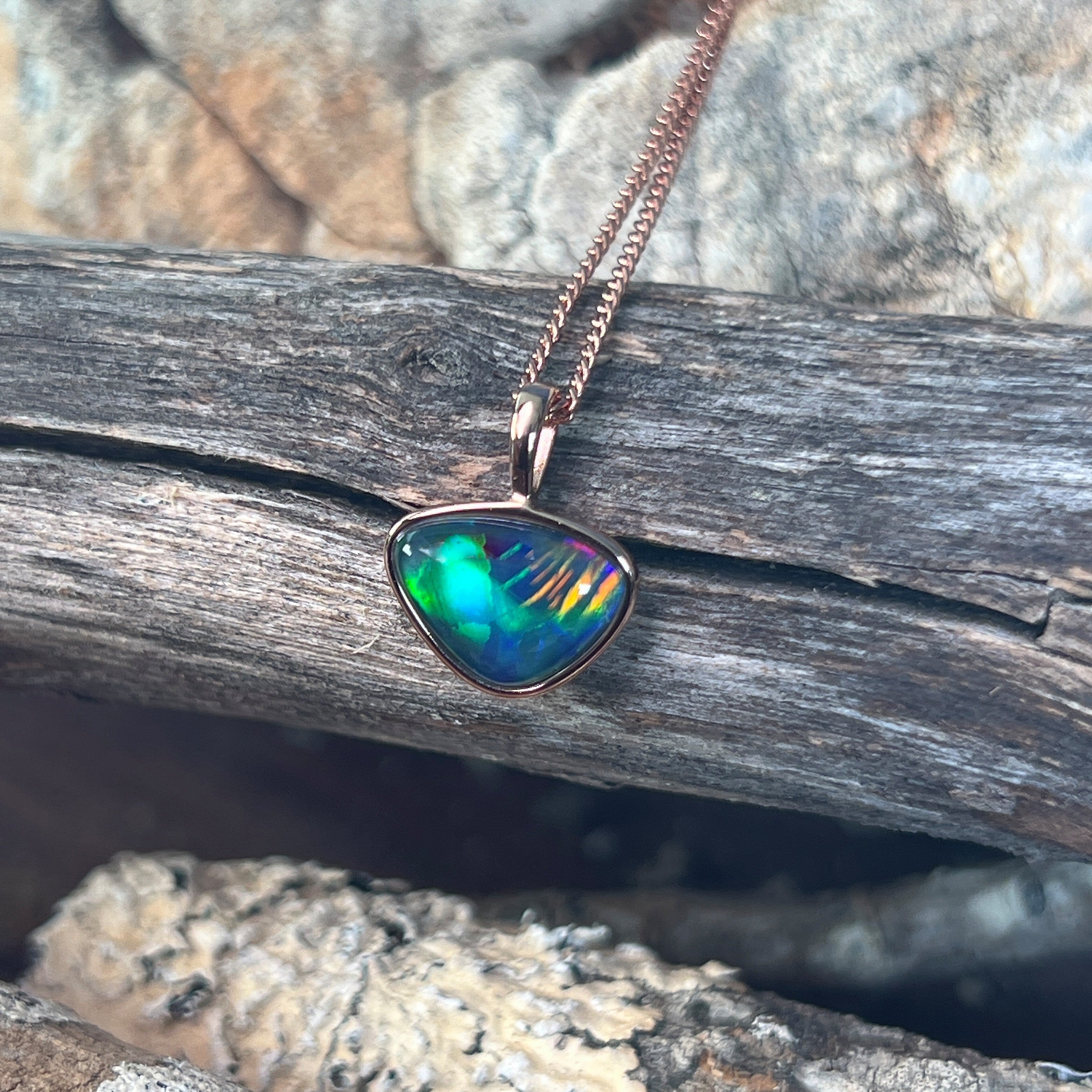 red, blue, green and yellow play-of-colour in a 9 x 11mm freeform Australian opal triplet pendant