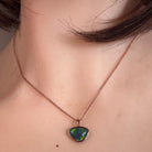 Australian opal triplet pendant worn at the neck, red, blue, green and yellow play-of-colour