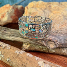 Close view of the opal inlay work on the wide sterling silver bangle