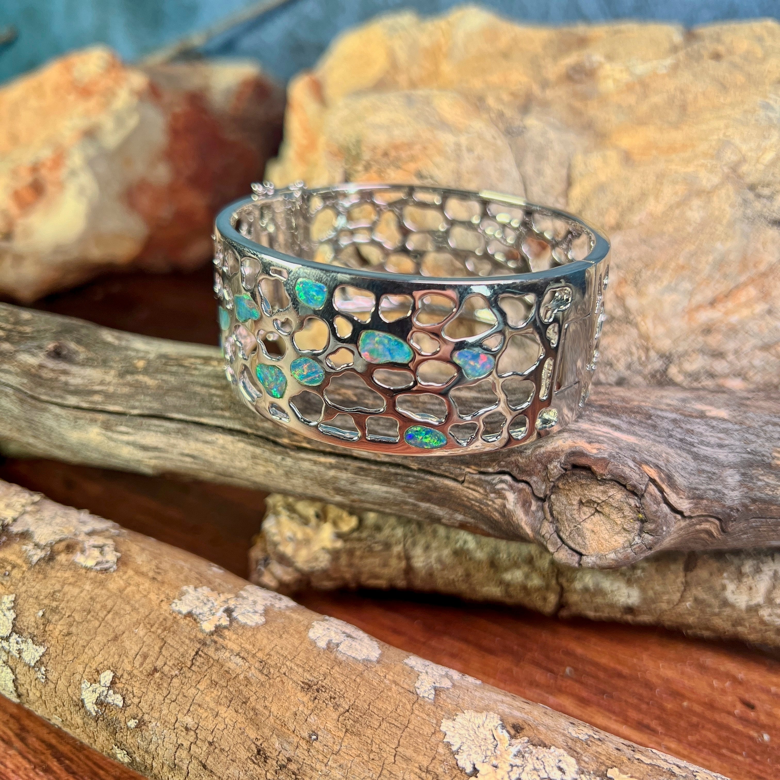 Close view of the opal inlay work on the wide sterling silver bangle