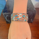 Wide Australian opal inlay bangle worn on the wrist