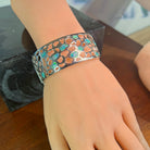 Opal inlay bangle on the wrist showing the full 26mm width