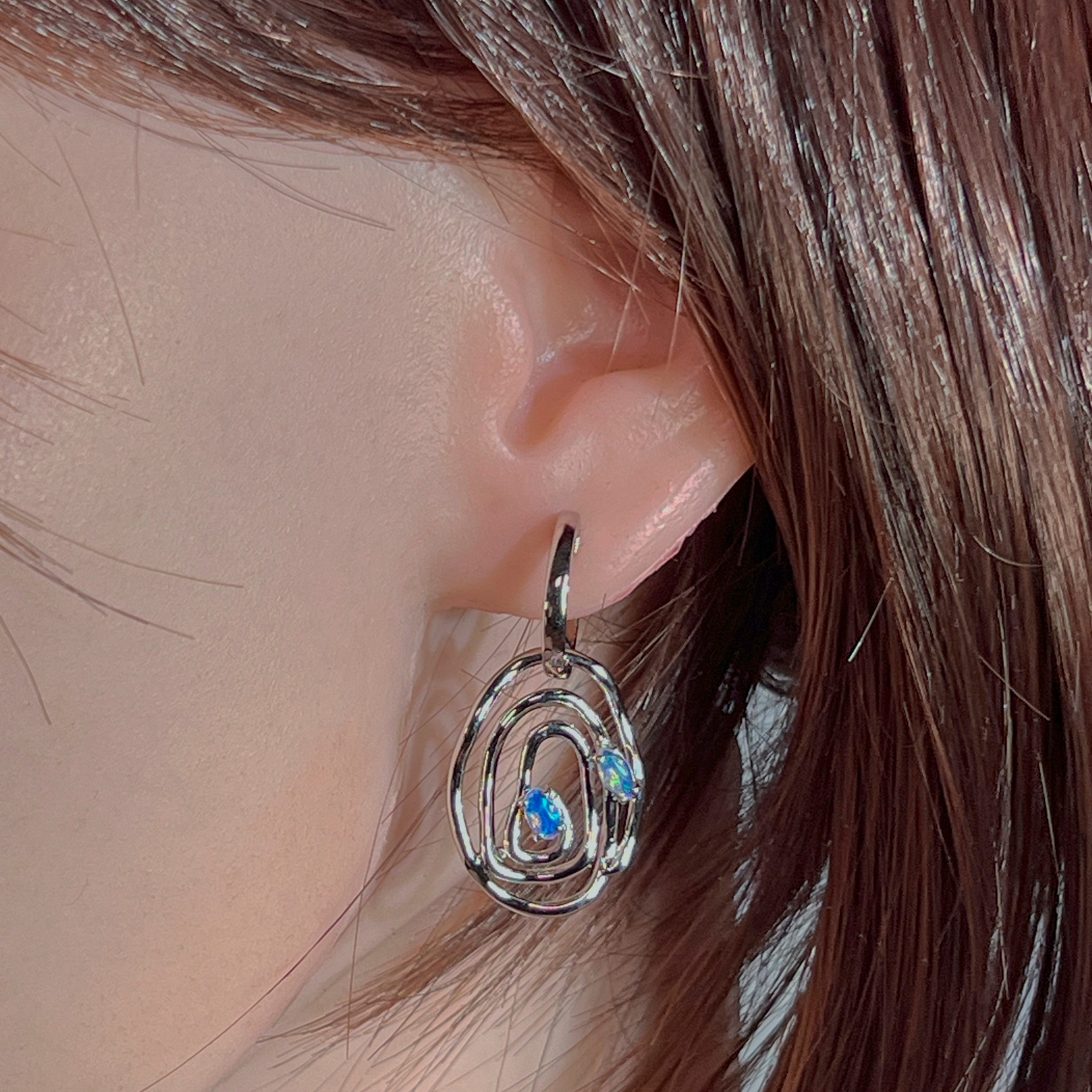 Sterling silver opal circle earrings showing the open circular design