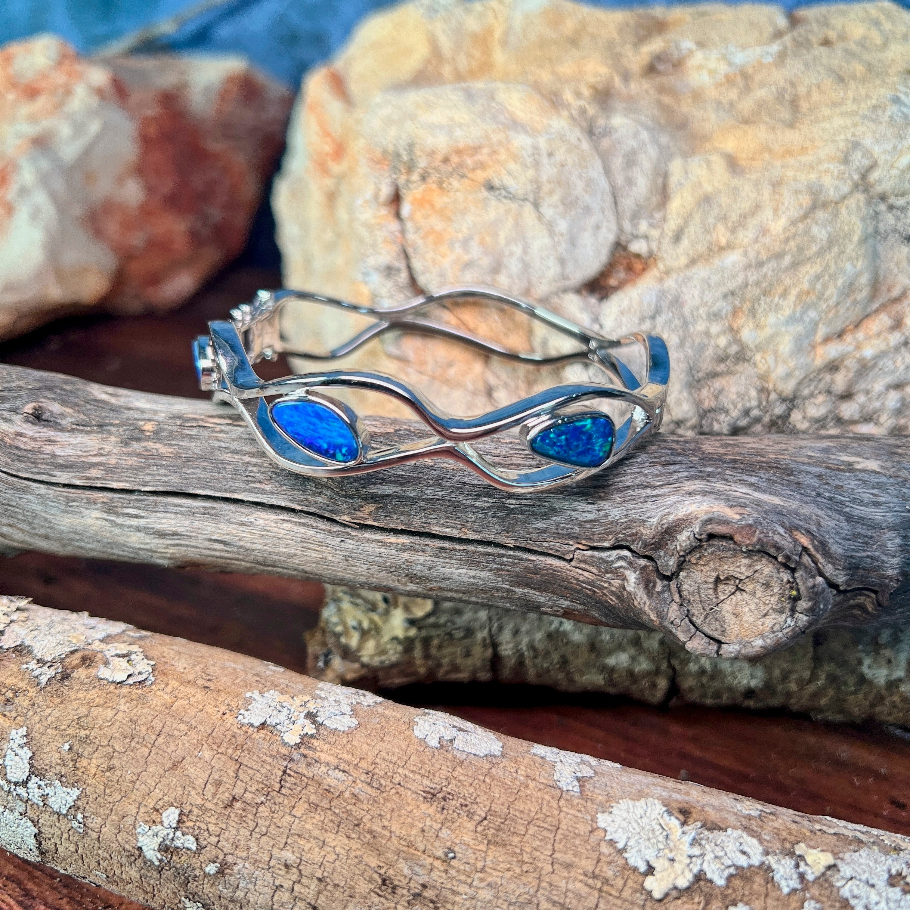 Side profile of the sterling silver wave cut-out bangle and its freeform opal doublet