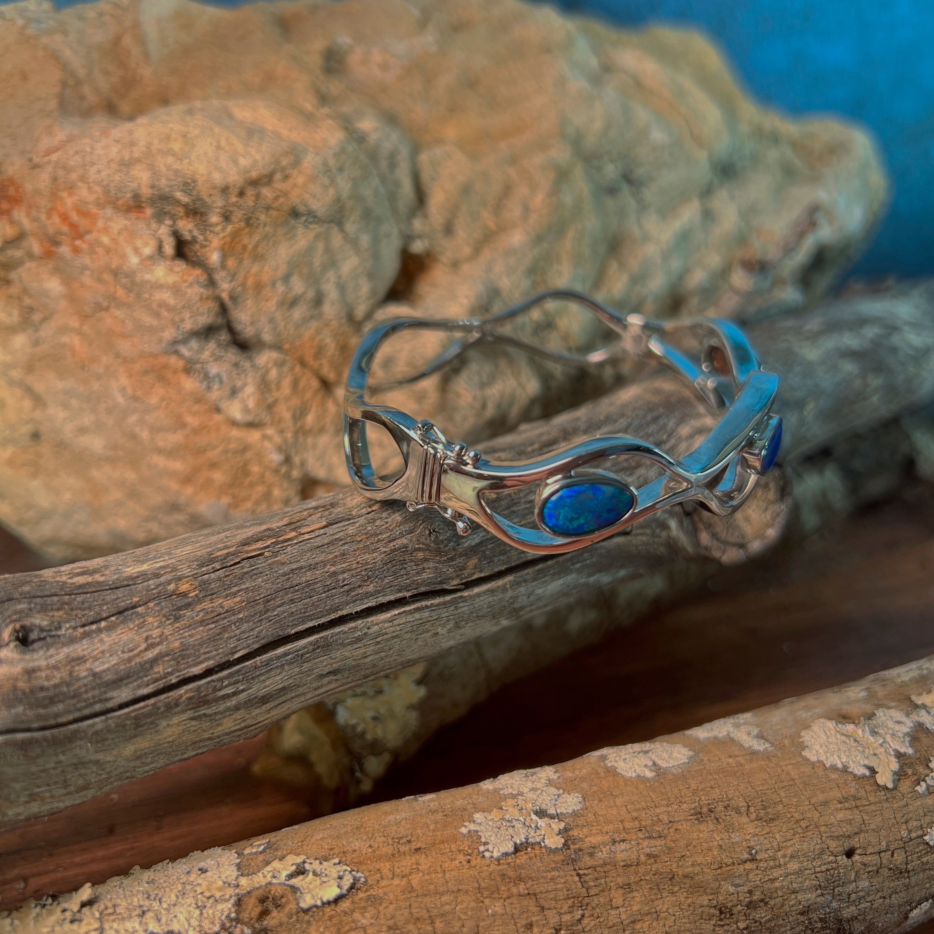 Close view of the 3.92ct freeform opal doublet set into the silver wave bangle