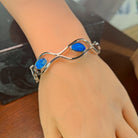 Australian opal doublet bangle in sterling silver, worn view showing scale