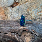 Freeform opal doublet ring in sterling silver showing green flash along the stone