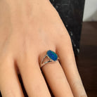 Freeform opal doublet ring in silver worn on the hand, showing its scale on the finger