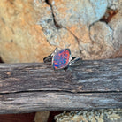 Marquise opal doublet ring in silver on driftwood, the marquise opal doublet catching the light