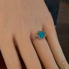 Oval opal doublet bypass ring in sterling silver worn on the hand, side view