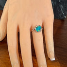 Sterling silver opal doublet ring worn on the hand, viewed across the fingers