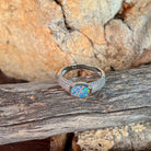 Close view of the blue, red and green play of colour in the oval opal doublet