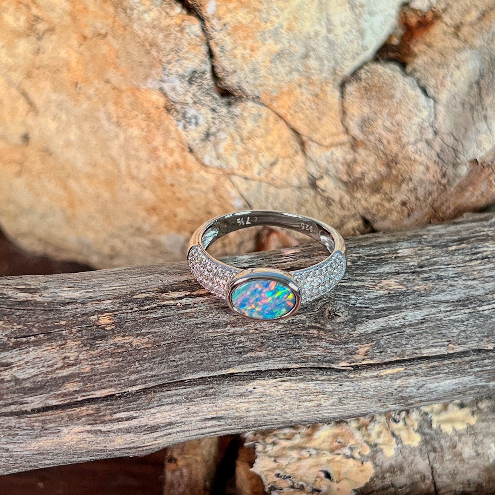 Close view of the blue, red and green play of colour in the oval opal doublet