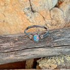 Close view of the blue, red and green play of colour in the oval opal doublet
