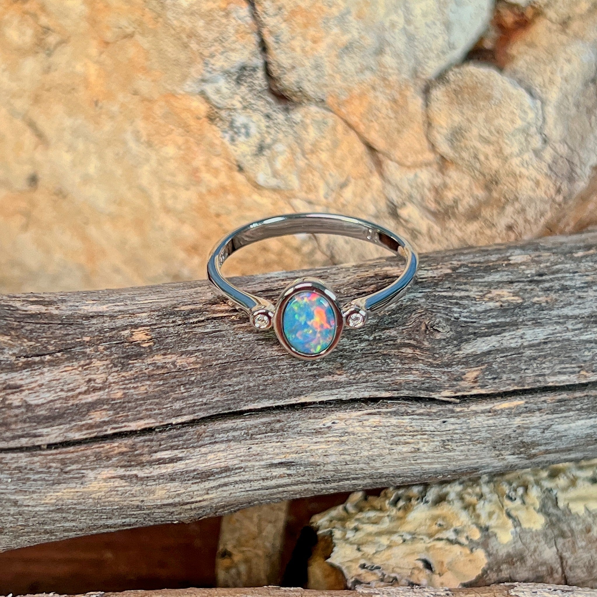 Close view of the blue, red and green play of colour in the oval opal doublet