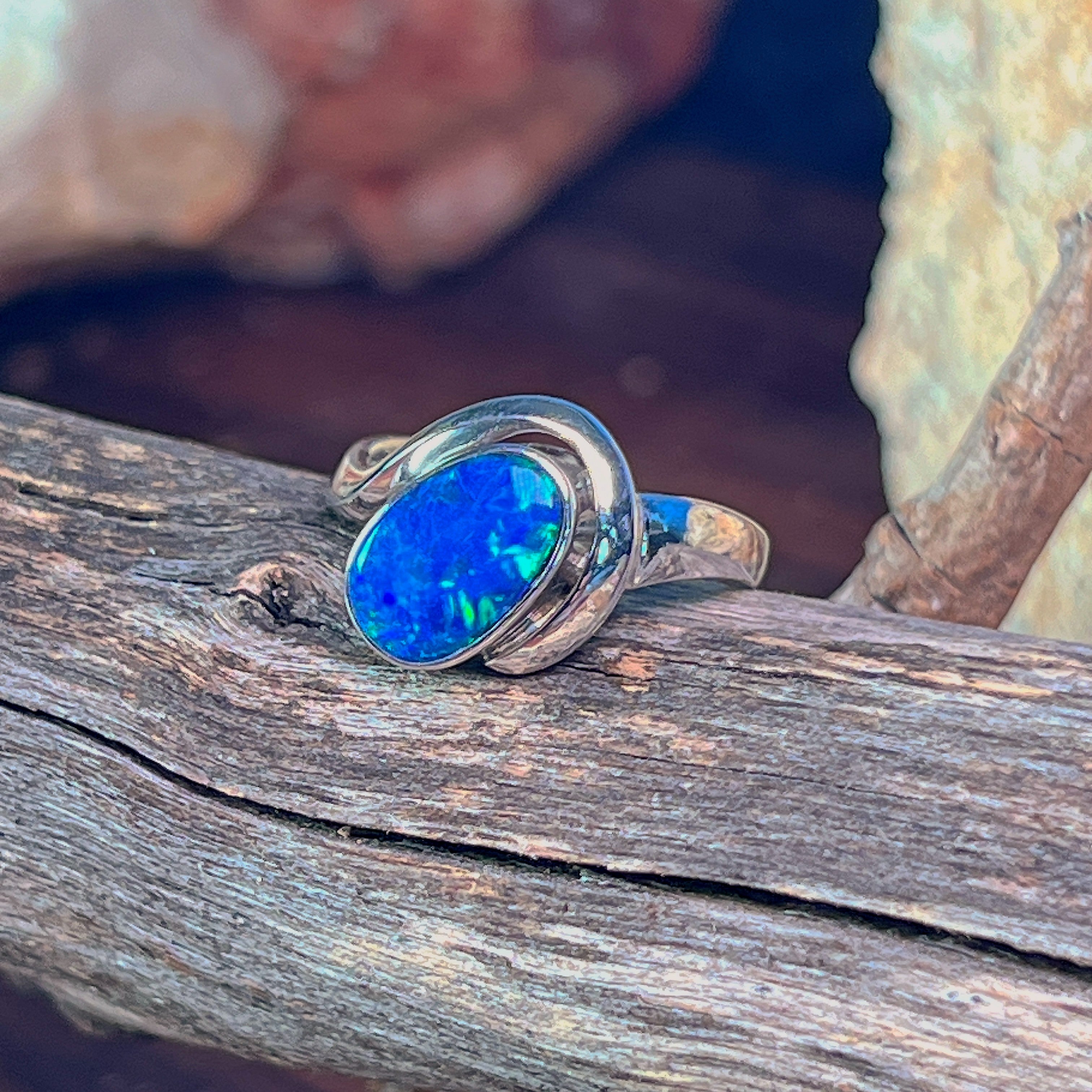 Deep blue-green opal doublet in a sterling silver setting, close view of the bezel