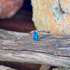 Close view of the blue, red and green play of colour in the oval opal doublet