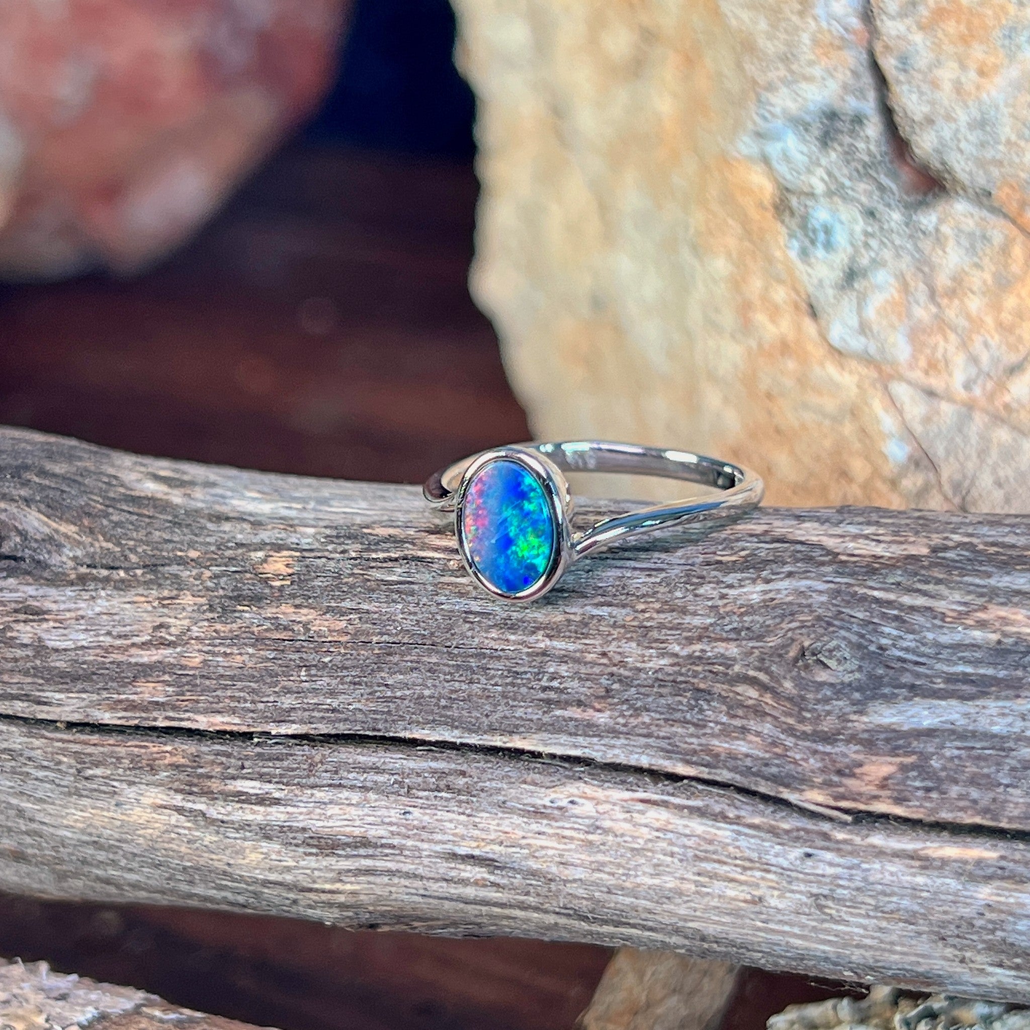 Close view of the blue, red and green play of colour in the oval opal doublet