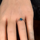 Deep green opal doublet ring in silver worn on the hand, showing its scale on the finger