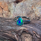 Bezel-set pear-shaped opal doublet in sterling silver, close view of the play-of-colour
