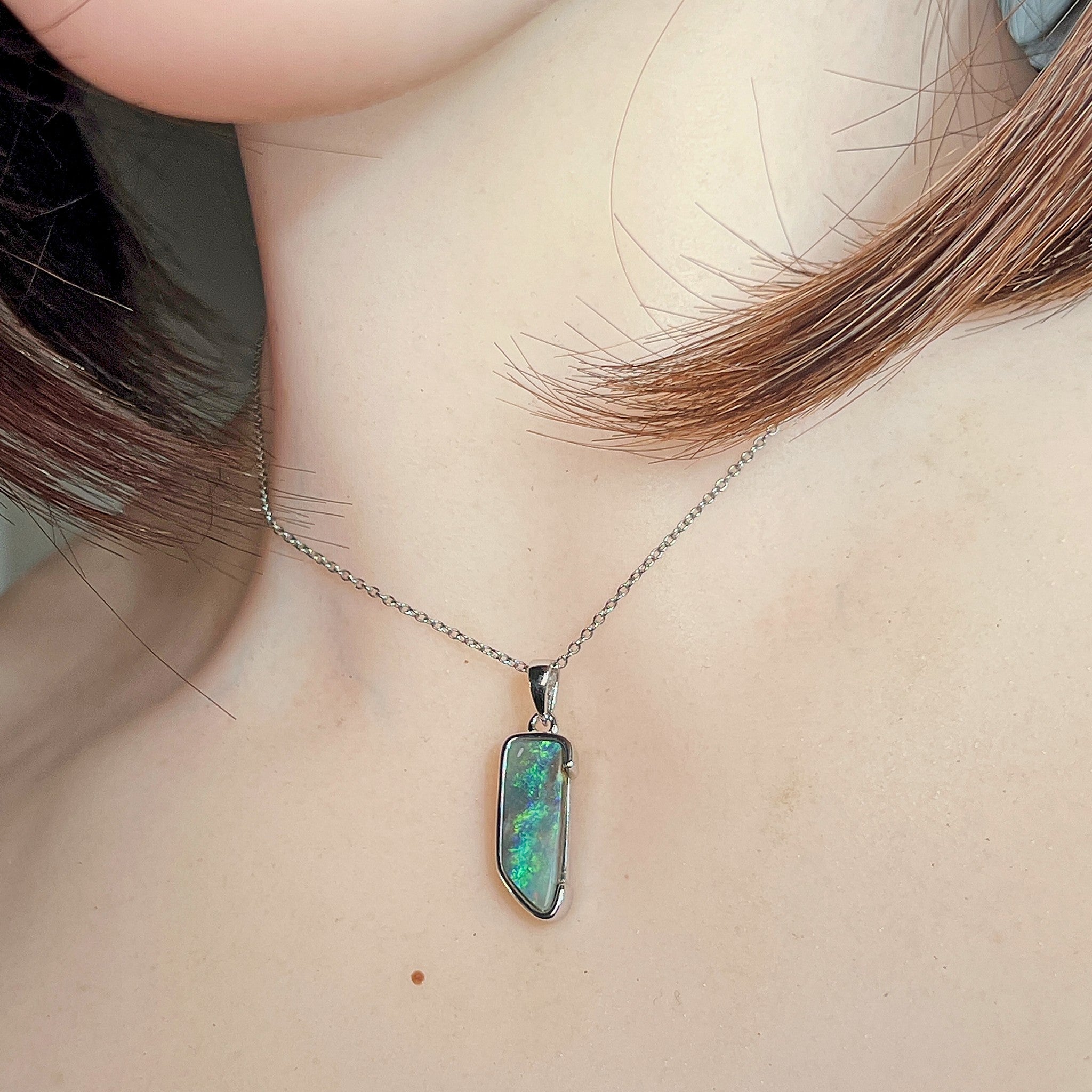 18 x 7mm freeform Australian boulder opal pendant worn at the neck, sterling silver