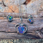 Silver heart opal triplet pendant and matching heart studs on weathered driftwood