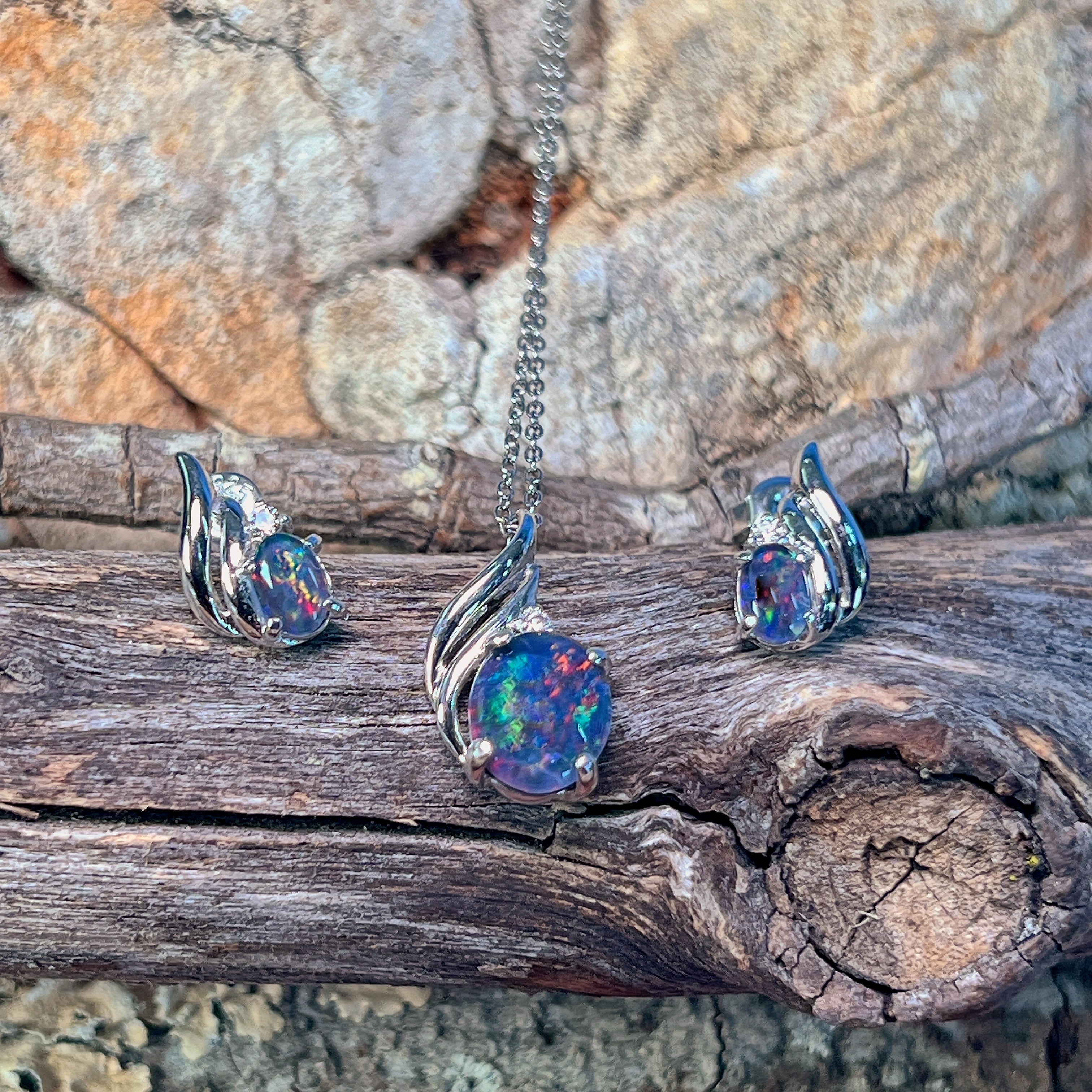 Silver opal triplet pendant and matching earrings with swirl detail on driftwood