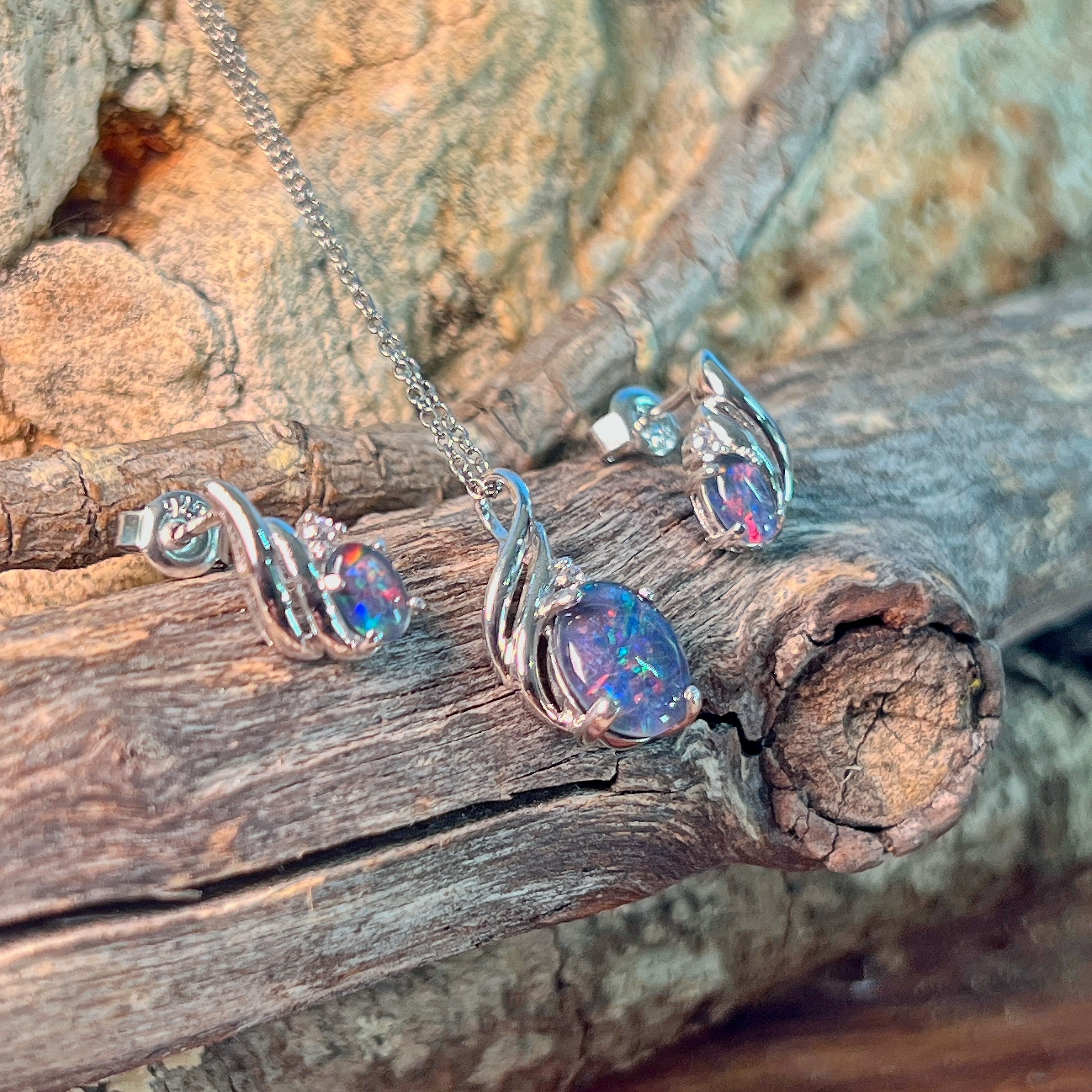 Sterling silver opal triplet set viewed against driftwood and sandstone
