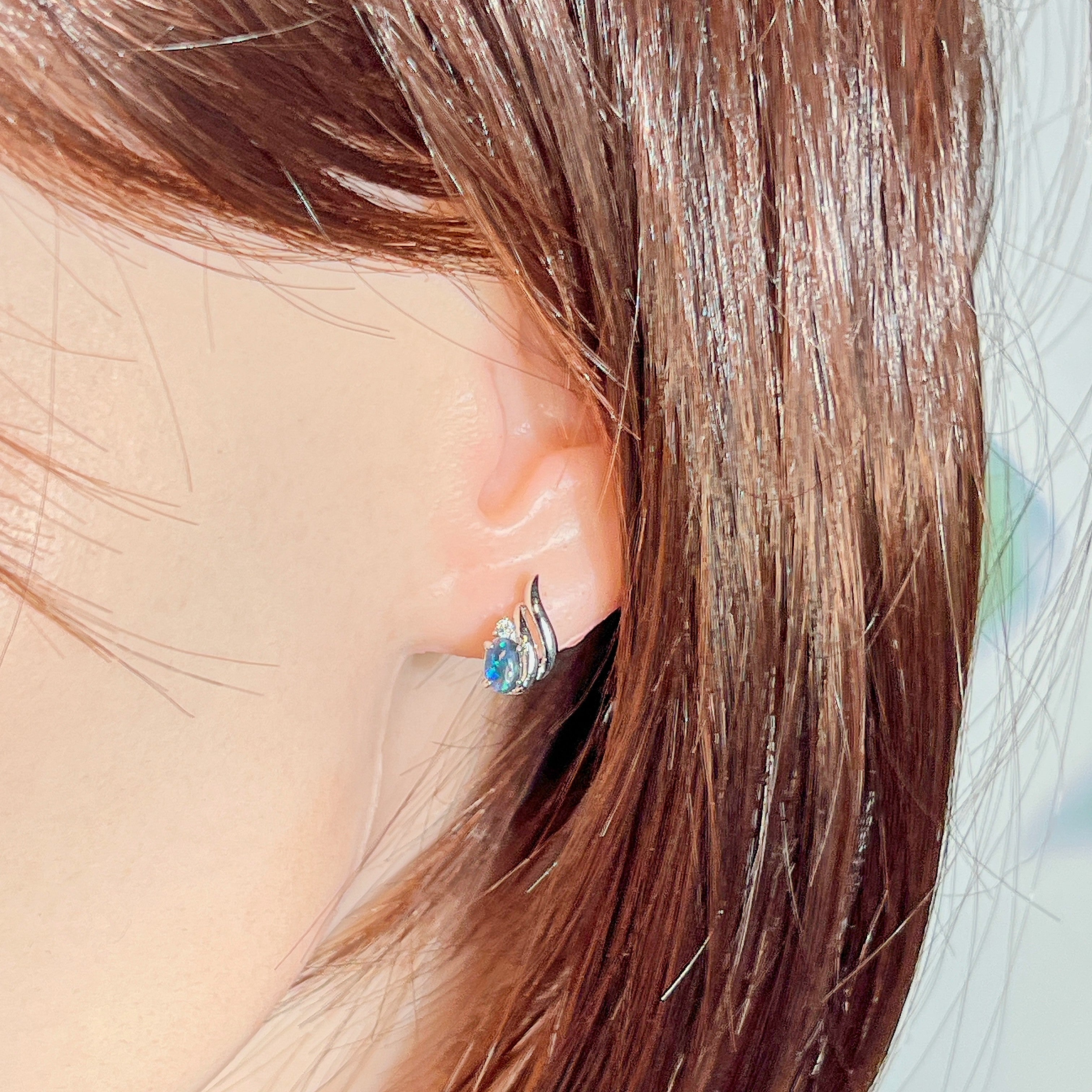 10x8mm opal triplet stud worn on the ear beneath loose hair