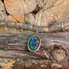 Opal triplet pendant in silver showing red, green and blue play-of-colour