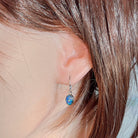 Model wearing the sterling silver opal triplet hook earring, showing drop length
