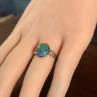 Australian opal triplet ring on the hand, sterling silver, 12 x 10mm oval stone