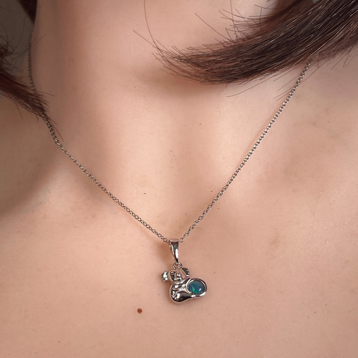 Worn Australian opal triplet pendant in sterling silver, blue, green and yellow, 5mm