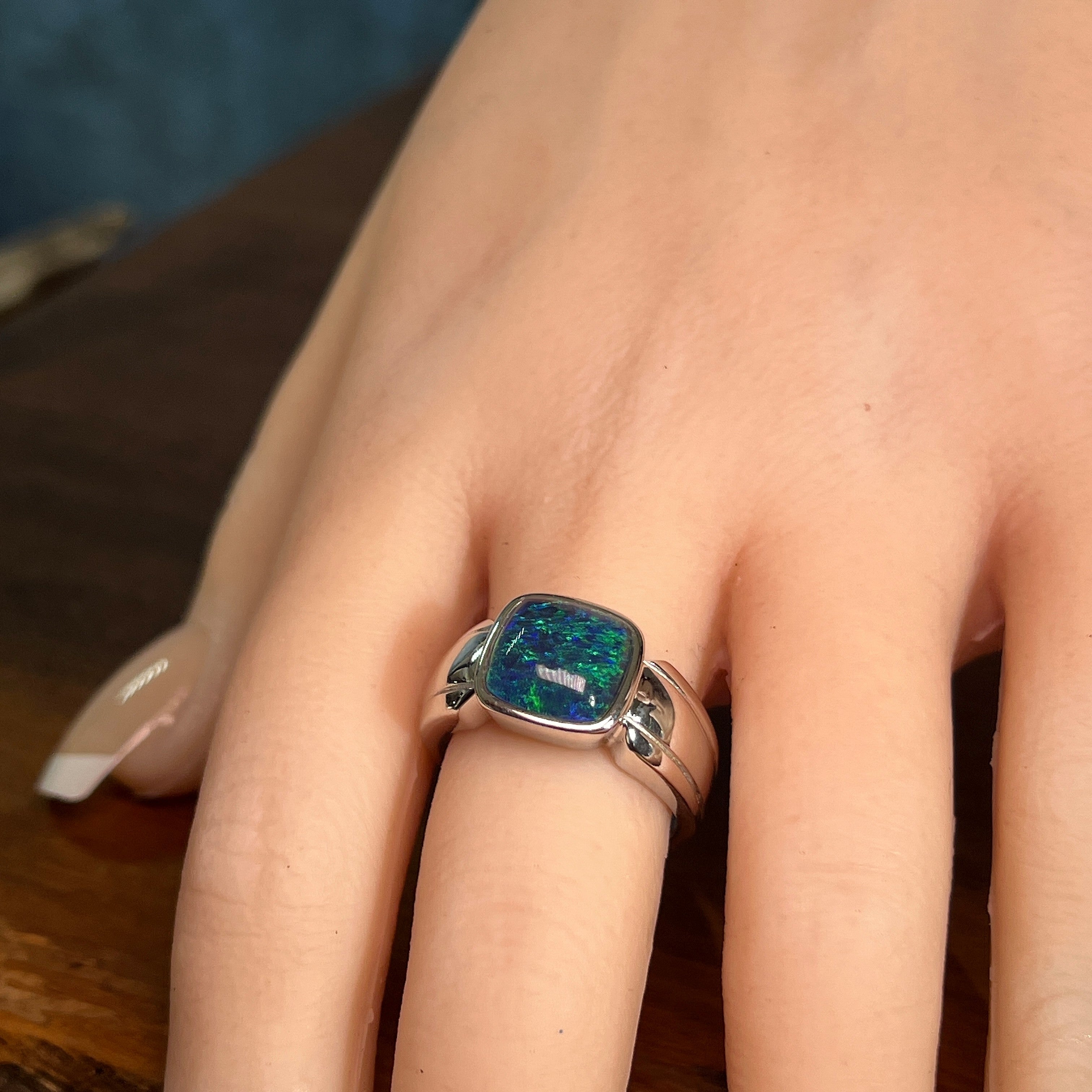 10 x 10mm cushion-shaped Australian opal triplet ring on the hand, sterling silver