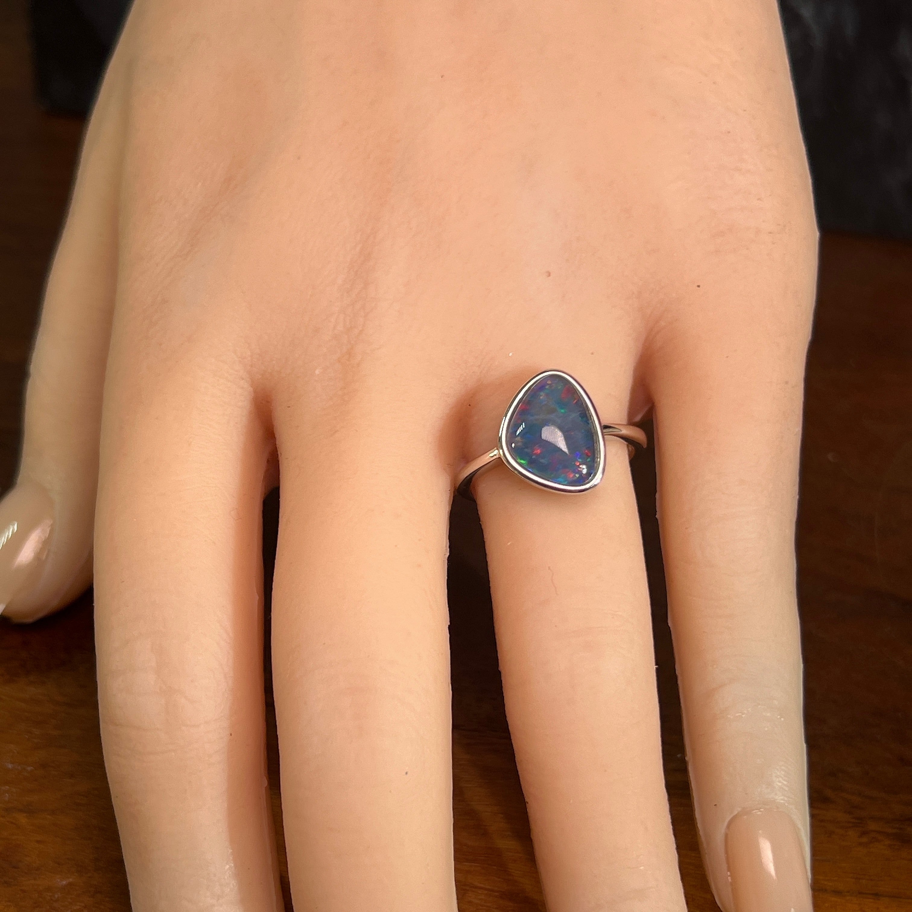 12.5 x 9.5mm triangular Australian opal triplet ring on the hand, sterling silver