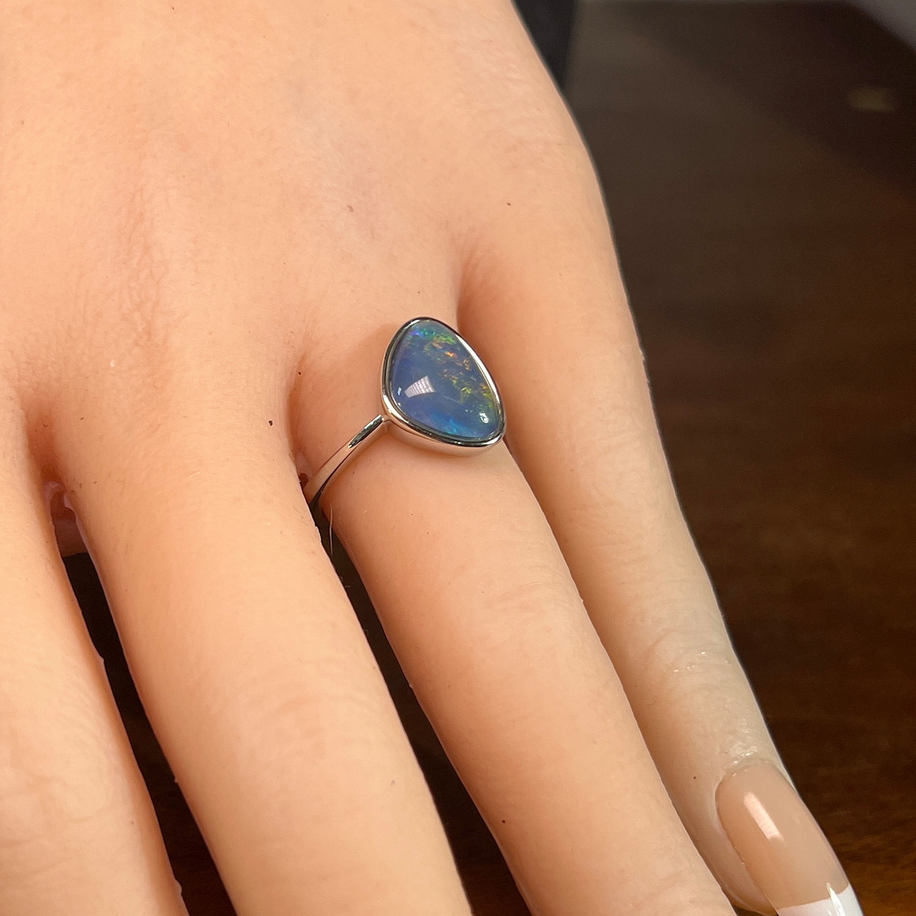 triangular Australian opal triplet ring worn, sterling silver, yellow, orange, blue and green
