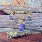Oval opal triplet pendant with accent stones showing blue and red play-of-colour