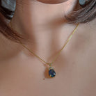 Gold-plated silver opal triplet pendant worn at the neckline, close view