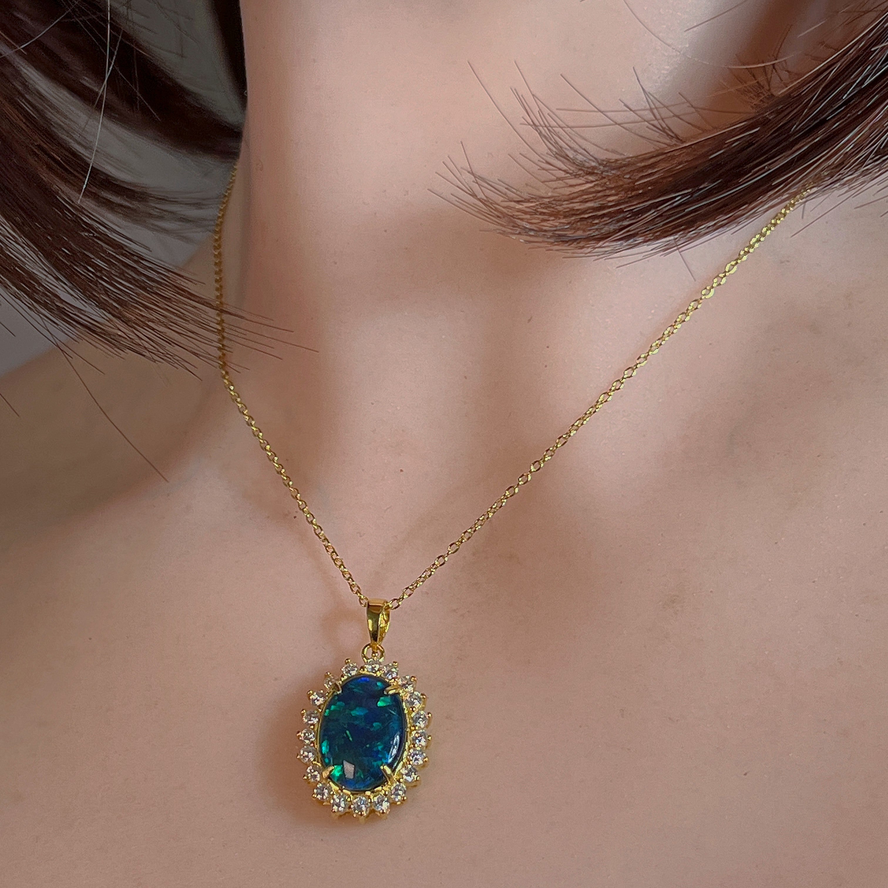 14x10mm opal triplet halo pendant worn at the neck, showing its scale on the collarbone