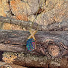 Opal triplet pendant with X-shaped bail in yellow gold-plated sterling silver, close view