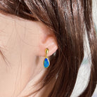 Worn Australian opal doublet earrings in yellow gold-plated silver, green and blue, 12 x 7mm