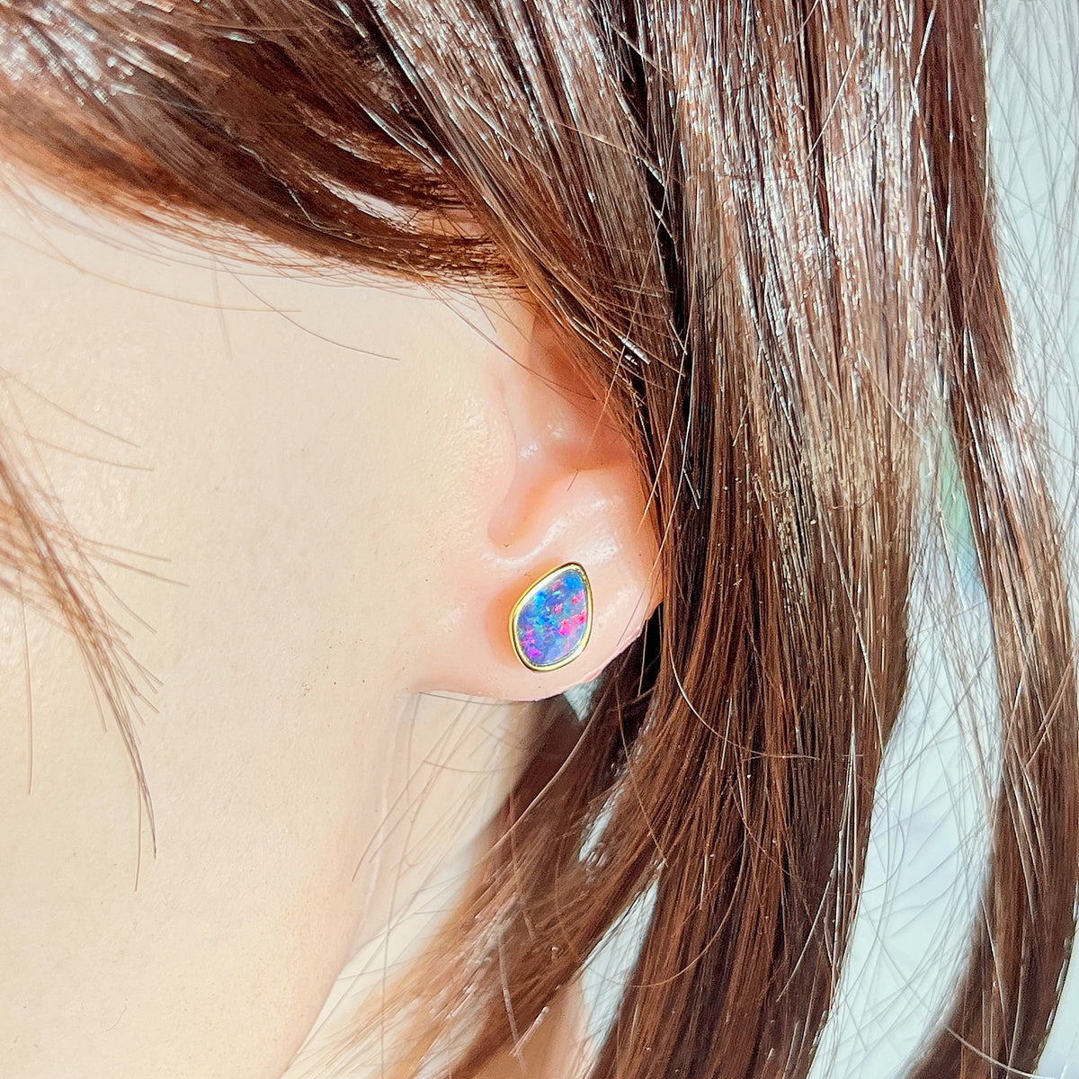 11 x 7.5mm freeform Australian opal doublet earrings worn on the ear, yellow gold-plated silver