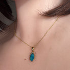 12 x 6.5mm oval Australian opal doublet pendant worn at the neck, yellow gold-plated silver