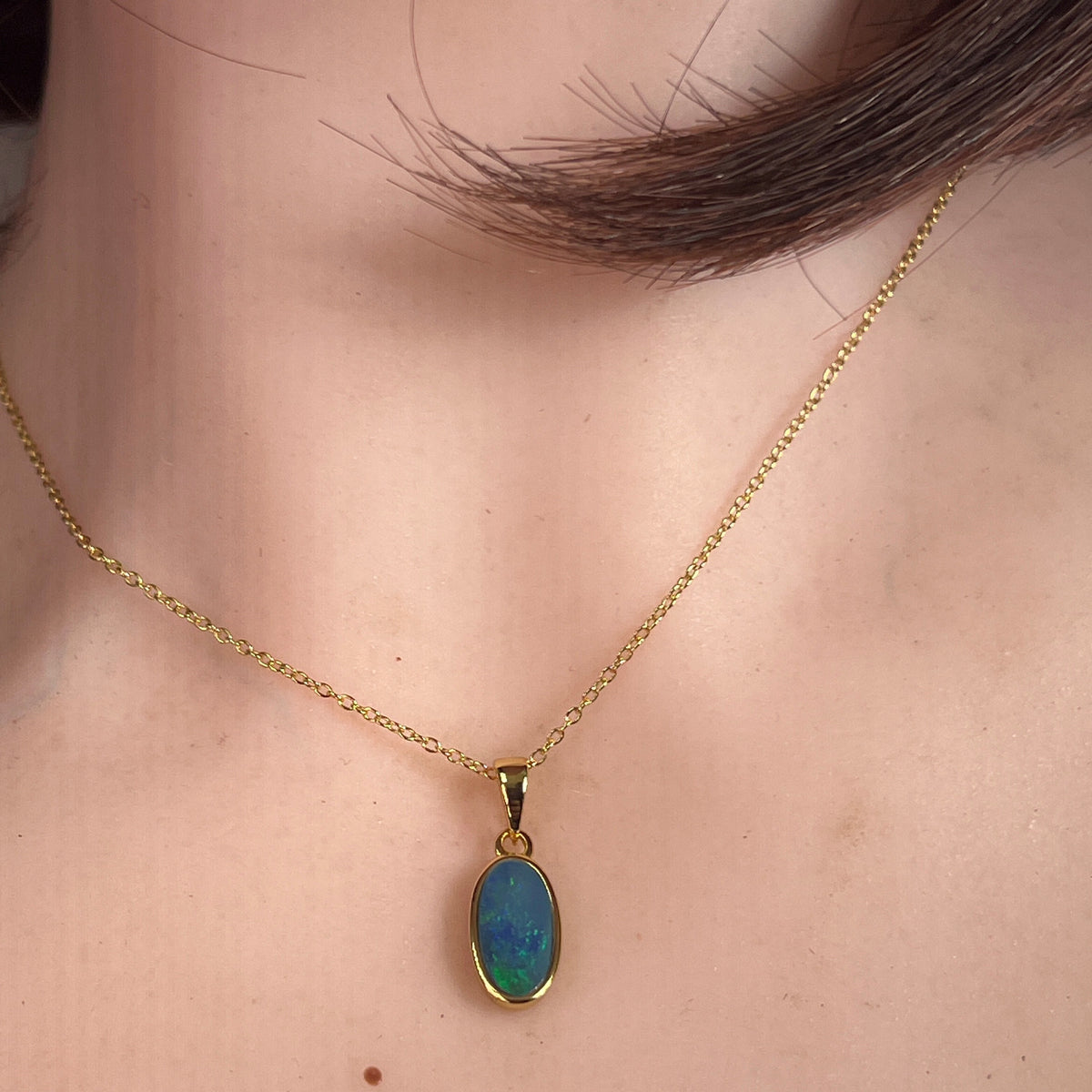 Worn Australian opal doublet pendant in yellow gold-plated silver, blue and green, 12 x 6mm