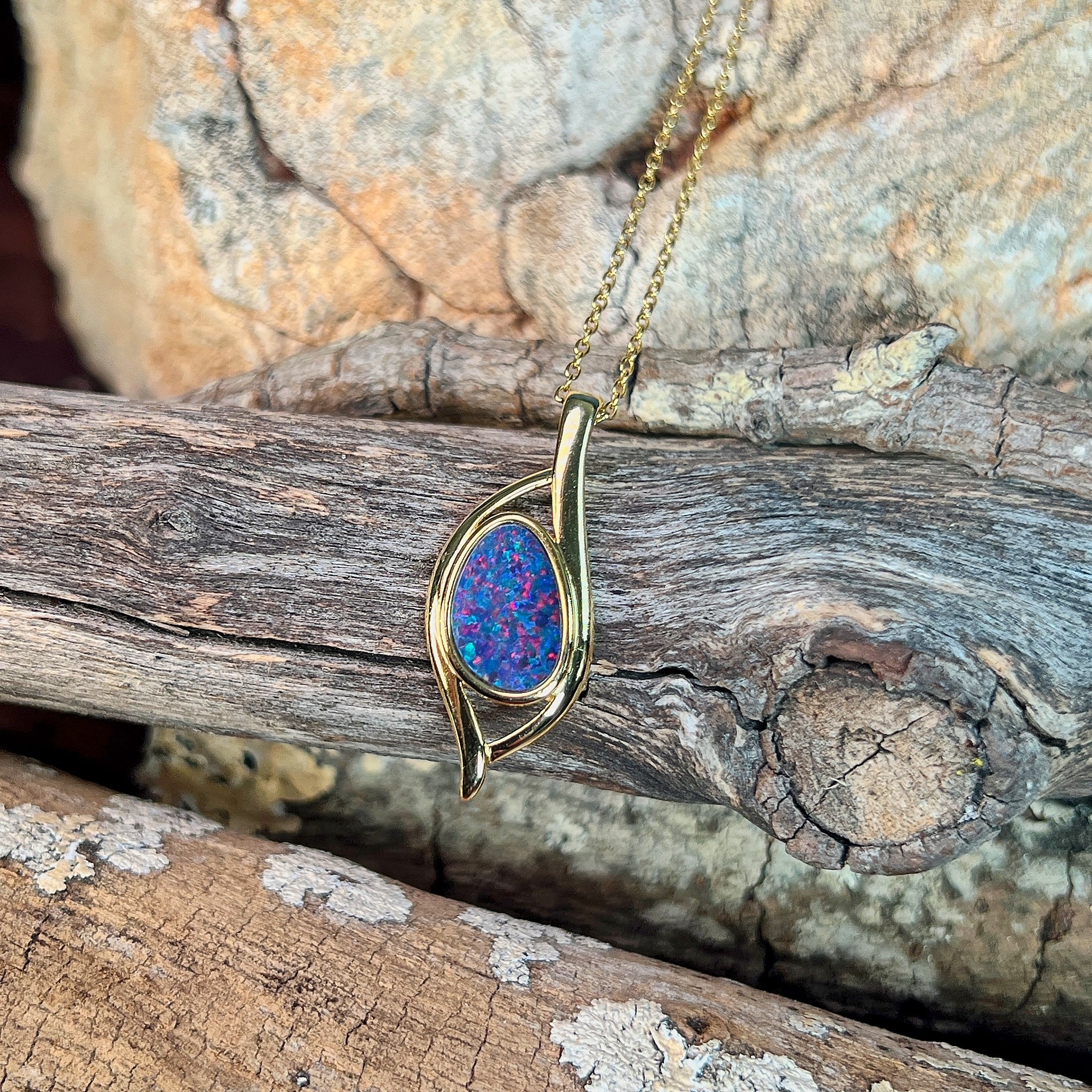 red and blue play-of-colour in a 12 x 8mm pear-shaped Australian opal doublet pendant