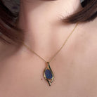 12 x 8mm pear-shaped Australian opal doublet pendant worn at the neck, yellow gold-plated silver