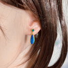 round Australian opal doublet earrings in yellow gold-plated silver, worn on the ear