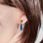Worn Australian opal doublet earrings in yellow gold-plated silver, green and blue, 16.5 x 7mm and 5mm