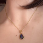 11 x 8mm freeform Australian opal triplet pendant worn at the neck, yellow gold-plated silver